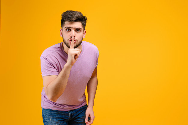 young-man-showing-silent-gesture-isolated-yellow-background_97712-87